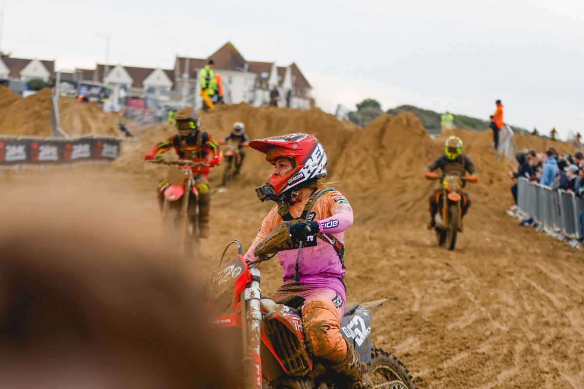 Dragon Energy sponsored motocross rider racing on a sand track