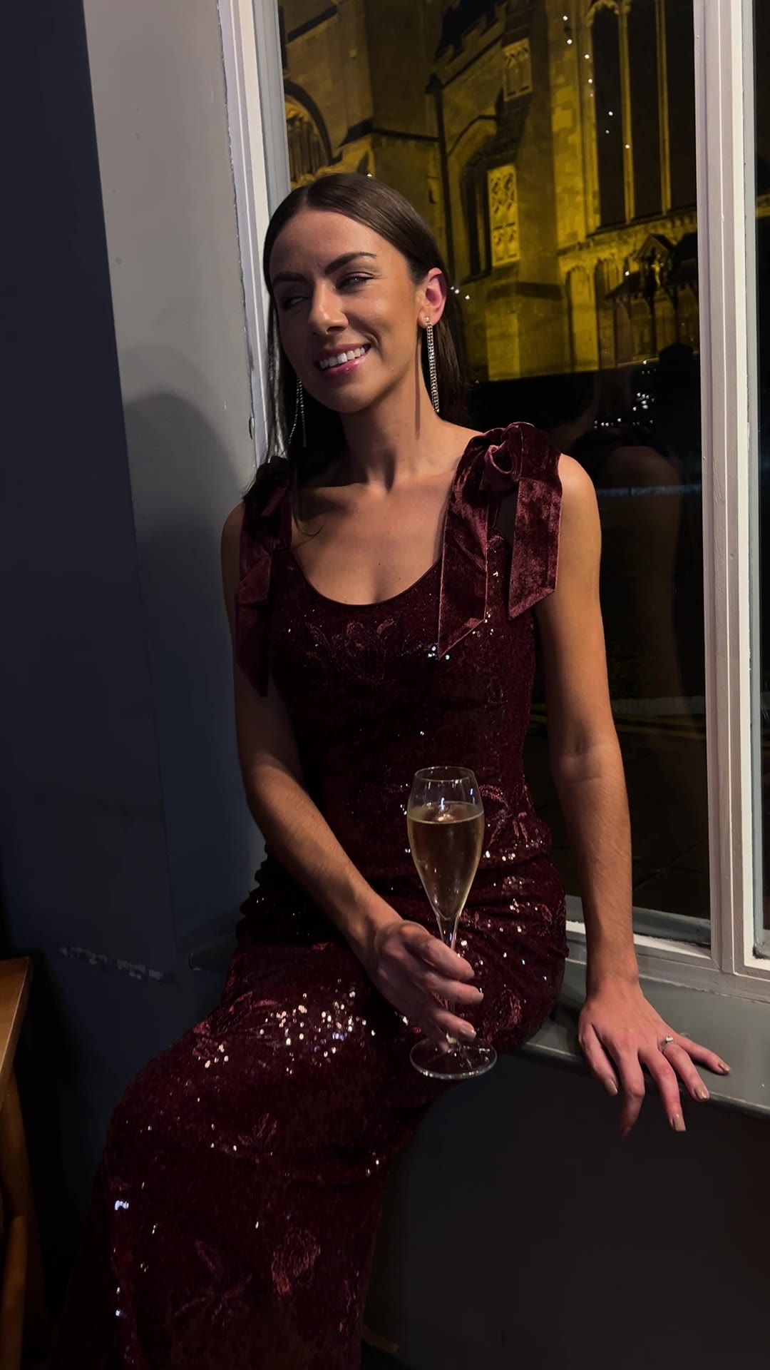 She Selected Christmas campaign — model in burgundy velvet dress with champagne