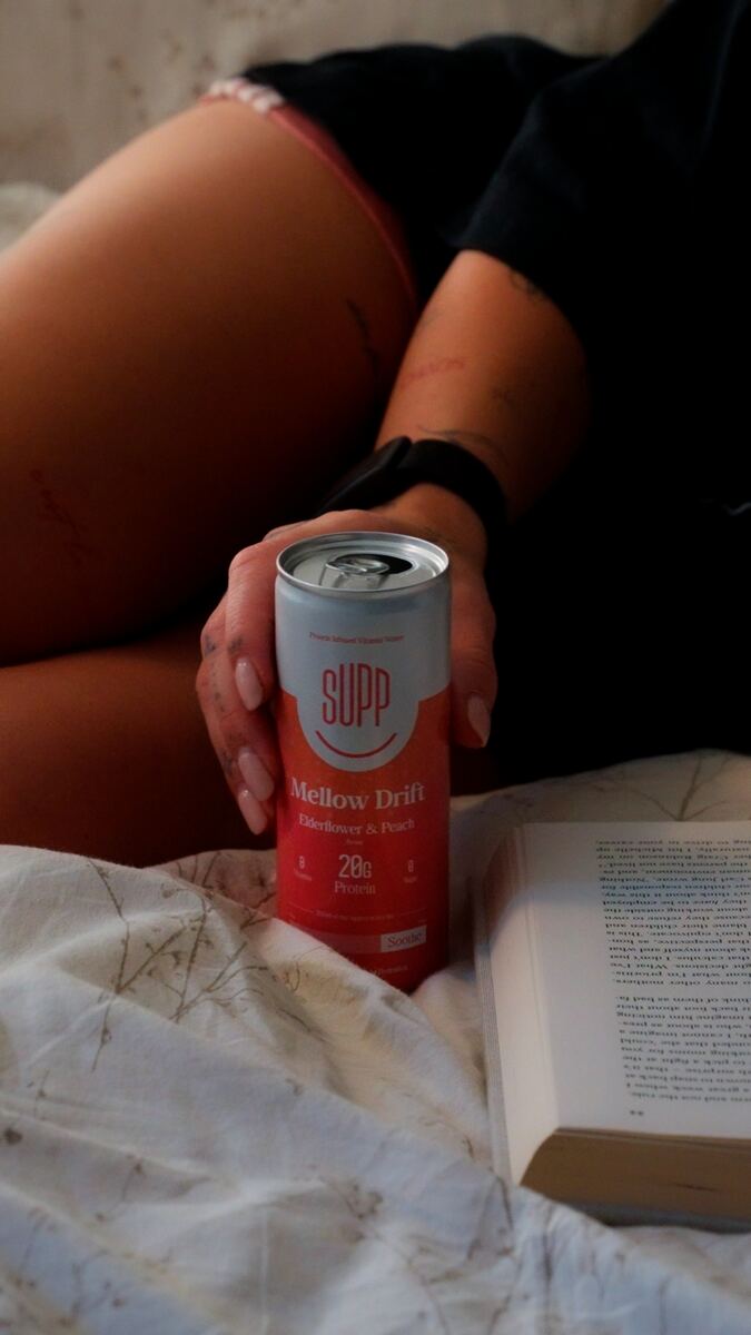 SUPPtember lifestyle shot — SUPP can with book